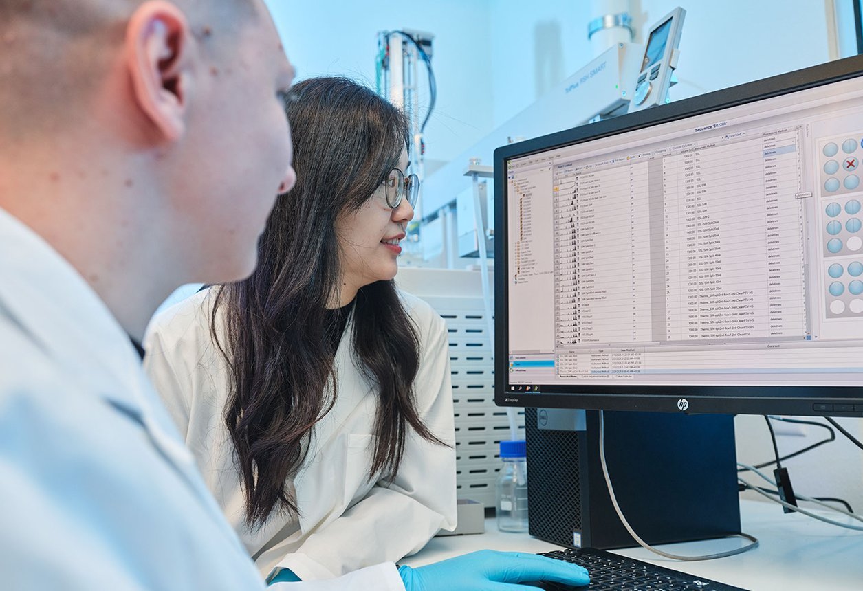 Two researchers analyzing software results together as part of PAL Solutions method development work