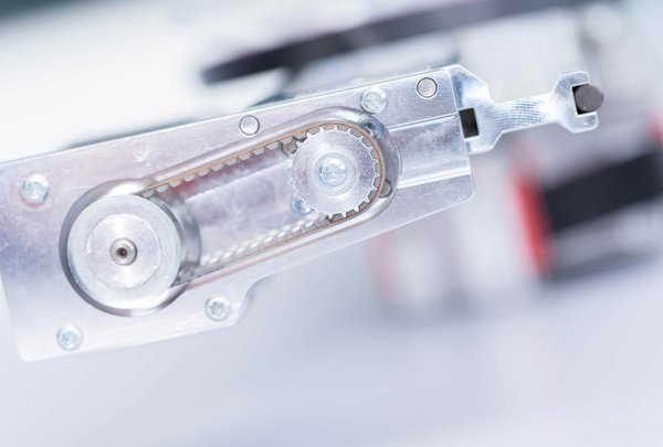 Close-up of a metallic mechanical component in a lab automation system, similar to parts used in PAL System